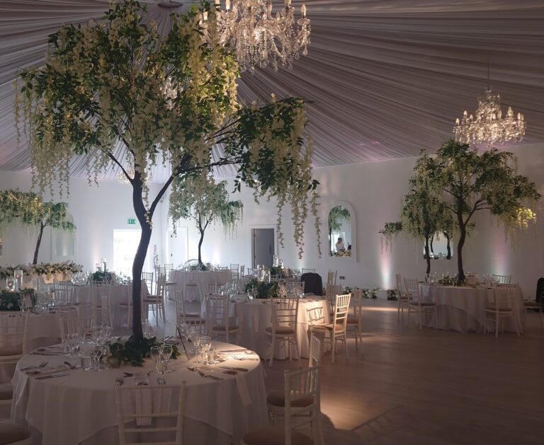 Wedding venue decor at Henblas Country Park using wisteria tree centrepieces